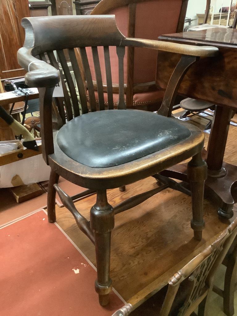 An early 20th century oak desk chair, width 66cm